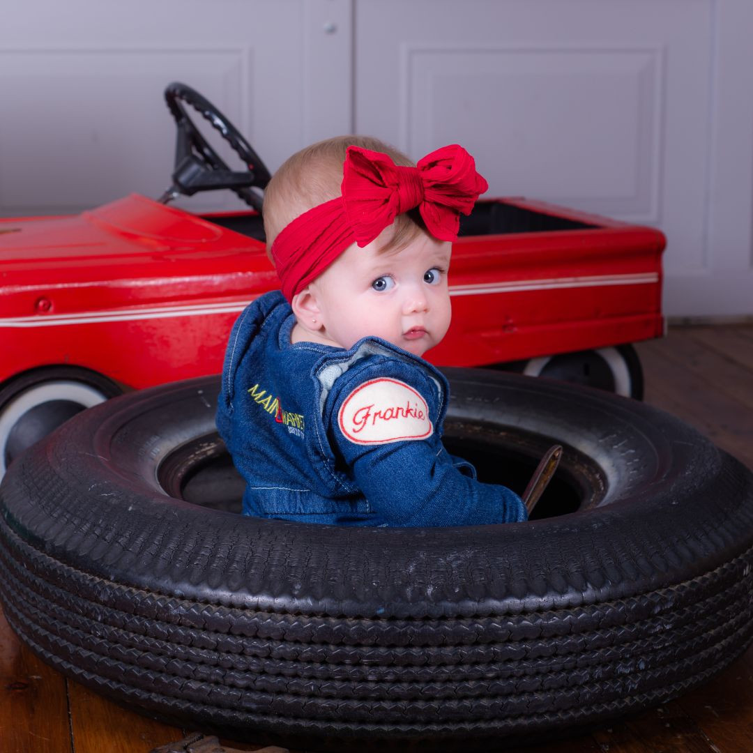 Picture of a baby sitting in a tire - Main & Market Service Centre